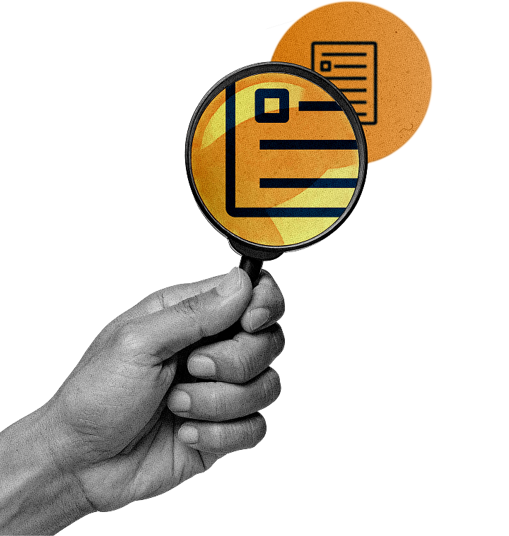 Hand holding a magnifying glass focused on a document icon